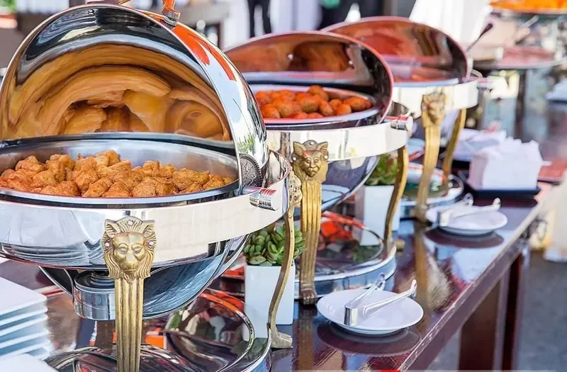 Evergreen Catering Silver chafing dishes with catering food for Bedford