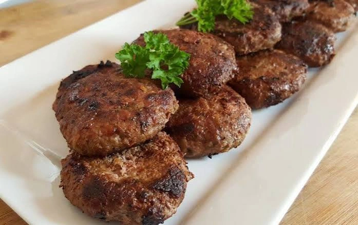 Lamb shami kebabs on a serving plate